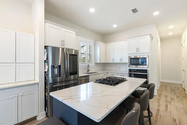 a kitchen with a refrigerator a stove a sink and a refrigerator