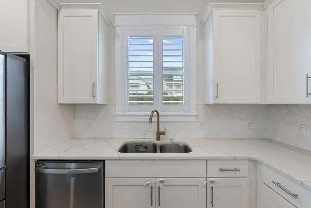 a kitchen with a sink cabinets and window