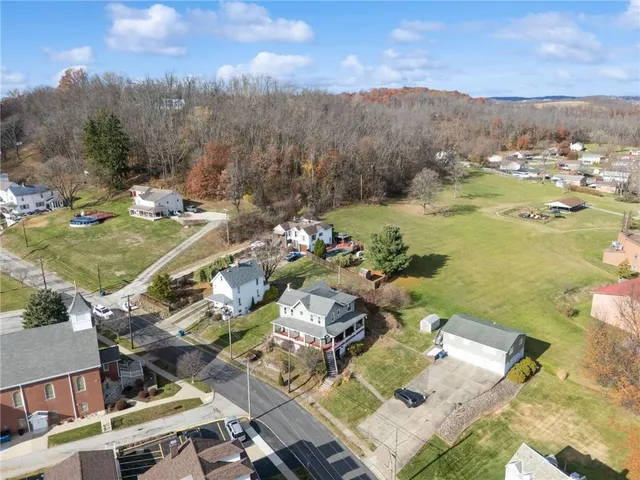 an aerial view of residential houses with outdoor space