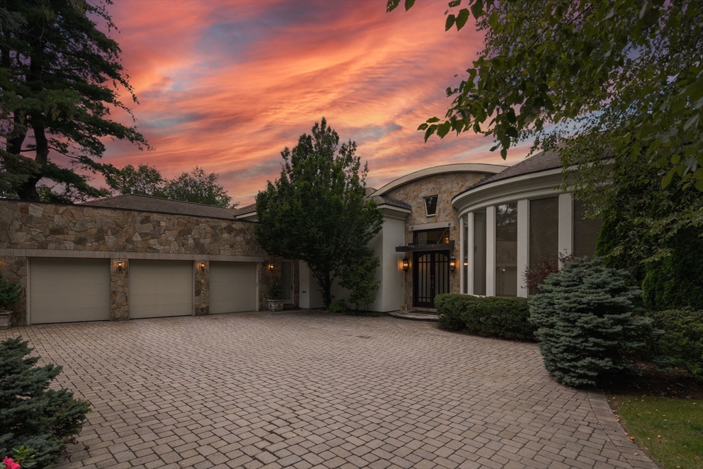 a front view of house with yard and trees