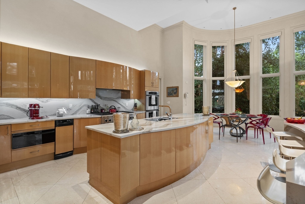 99 Baldpate Hill Road Newton, MA 02459 - Photo 6 of 28 a kitchen with stainless steel appliances granite countertop a sink stove and cabinets
