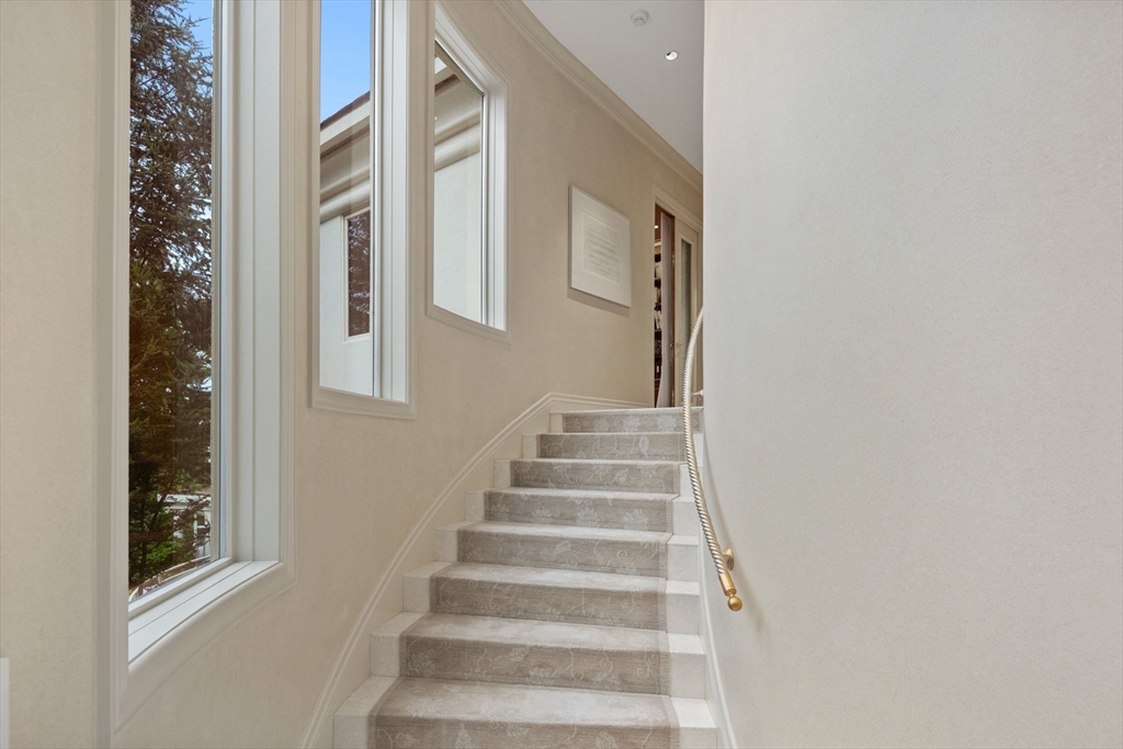 99 Baldpate Hill Road Newton, MA 02459 - Photo 9 of 28 a view of staircase with white walls and windows