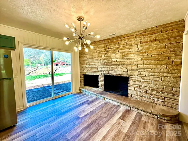 a view of livingroom with wooden floor and a fireplace