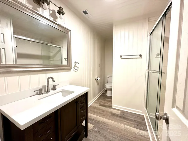 a bathroom with a sink a mirror and a shower