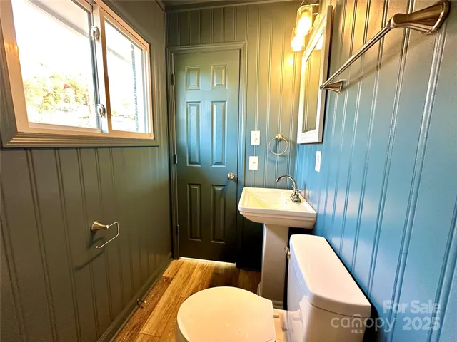 a bathroom with a sink a toilet a mirror and vanity