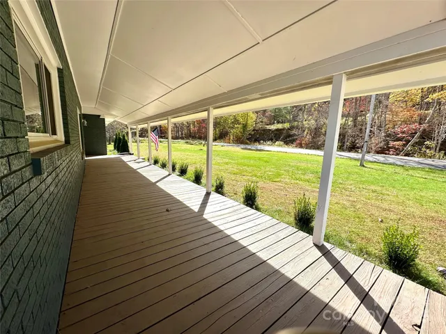 a view of a wooden deck with a yard