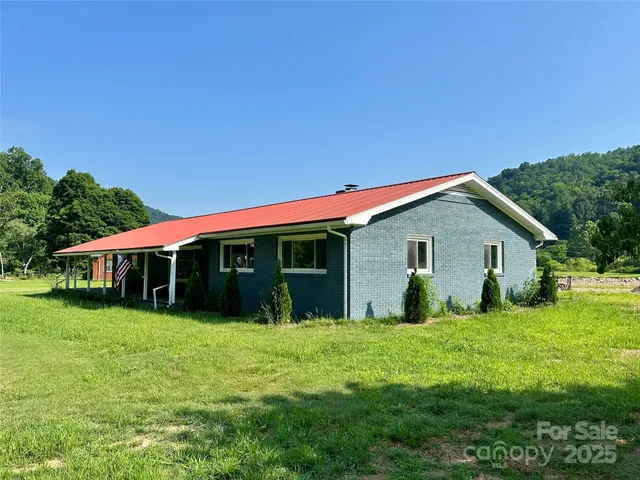 a view of a house with yard and sitting area