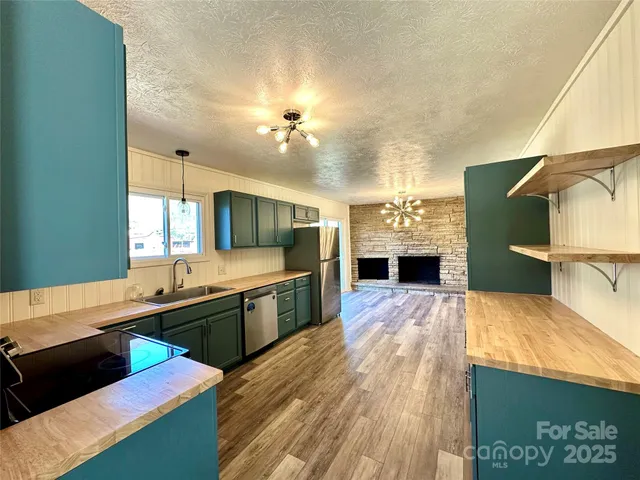 a large kitchen with kitchen island a stove and a sink