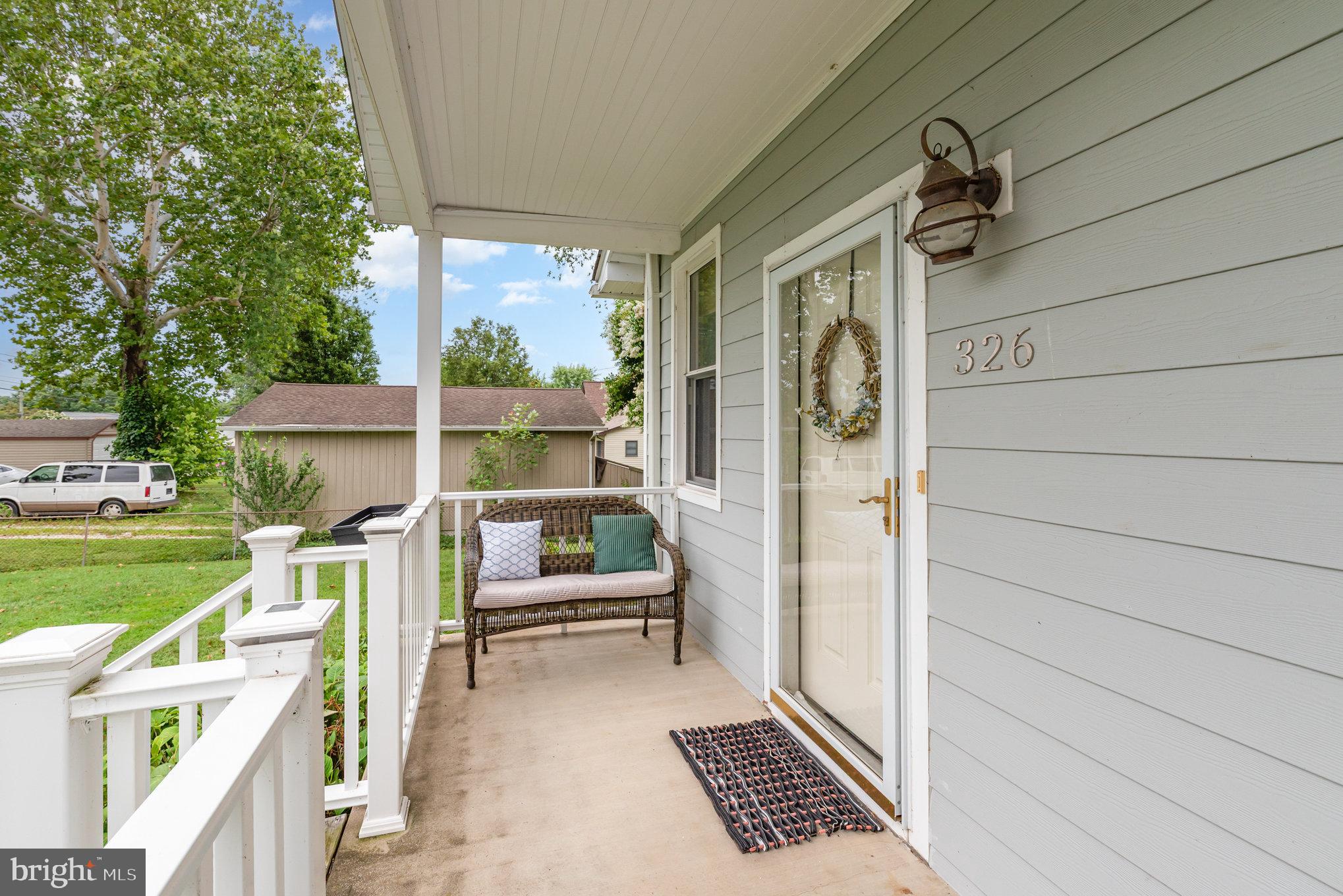 326 Wye Road Baltimore, MD 21221 - Photo 6 of 56 a view of a porch with furniture and a yard