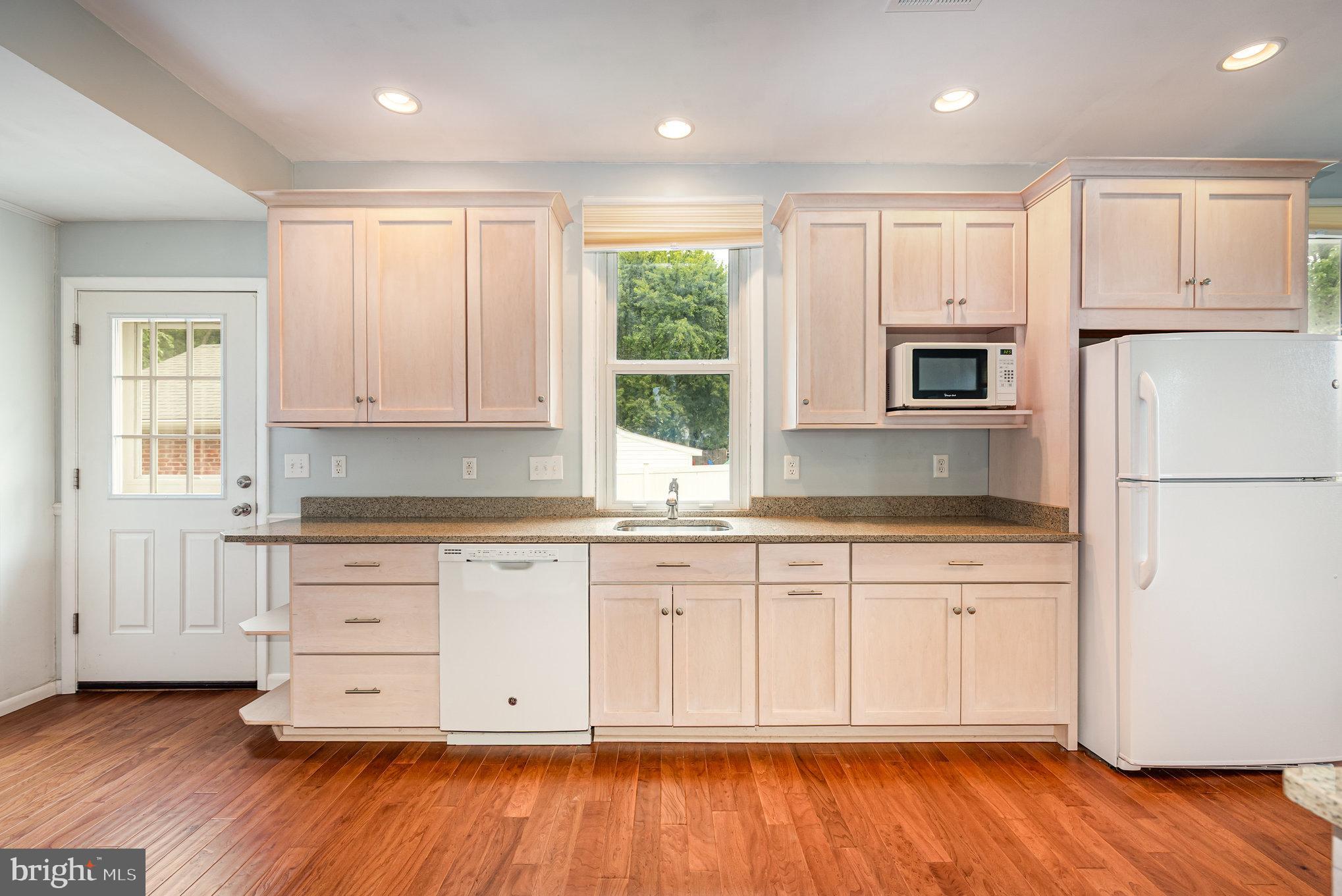 326 Wye Road Baltimore, MD 21221 - Photo 10 of 56 a kitchen with granite countertop white cabinets and wooden floor