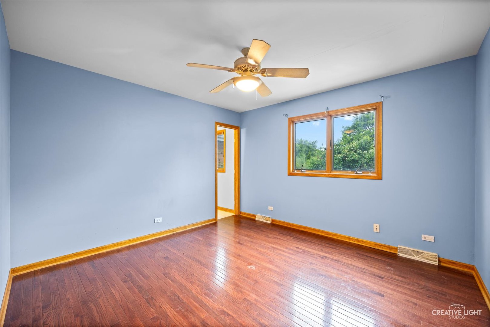 1325 East Lake Avenue Glenview, IL 60025 - Photo 23 of 43 a view of an empty room with window and wooden floor