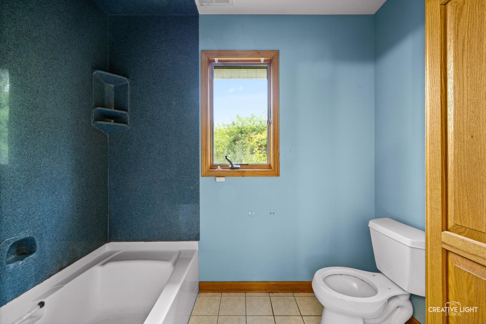 1325 East Lake Avenue Glenview, IL 60025 - Photo 32 of 43 a bathroom with a sink a toilet a window and a bathtub