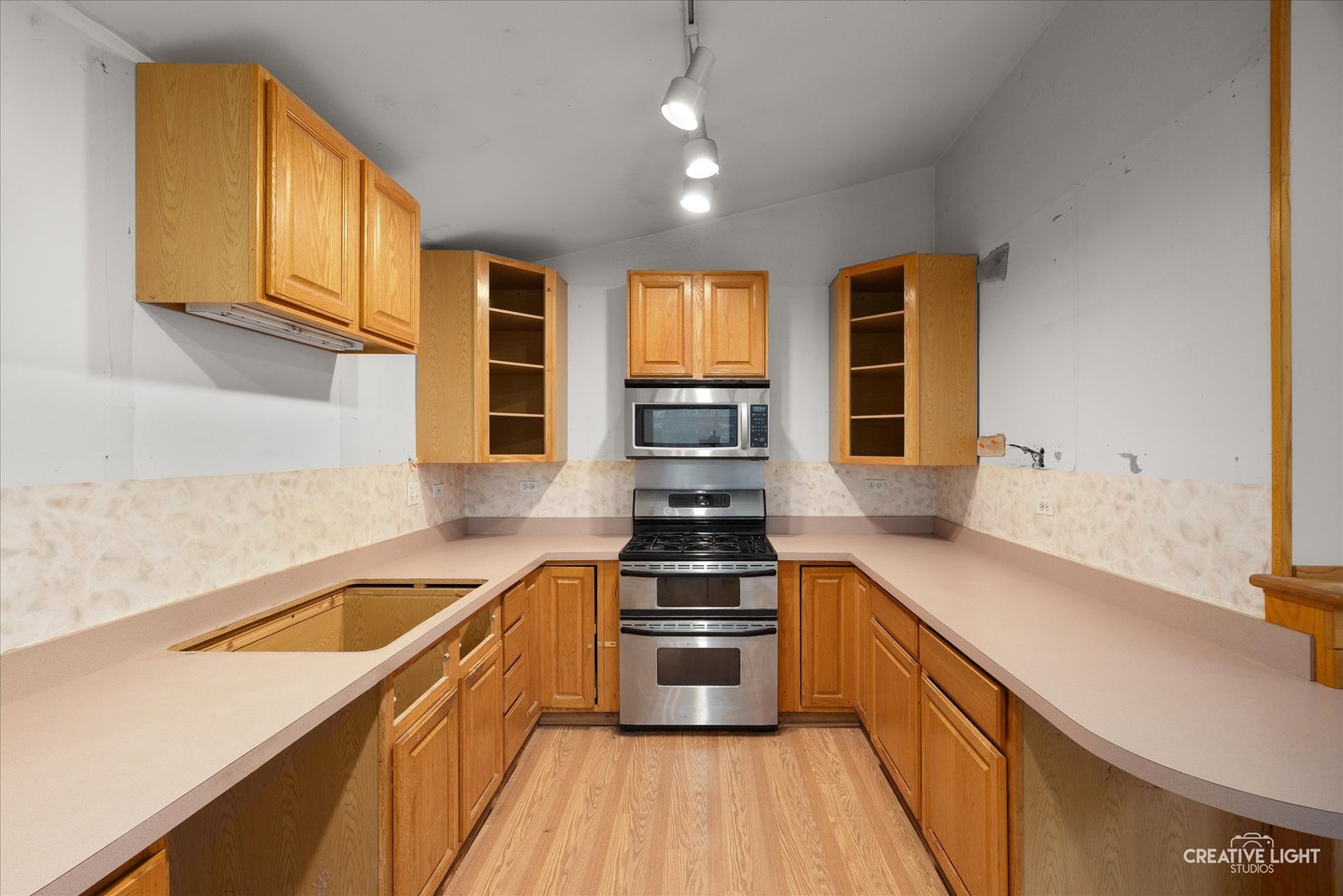 1325 East Lake Avenue Glenview, IL 60025 - Photo 8 of 43 a kitchen with stainless steel appliances a stove sink and cabinets
