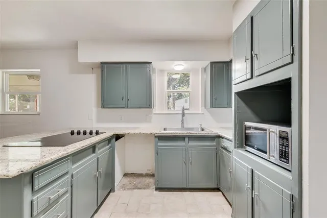 a kitchen with a sink stove and microwave