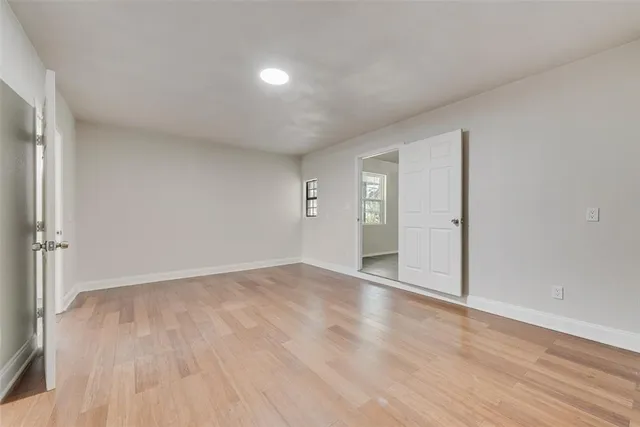 a view of an empty room and wooden floor