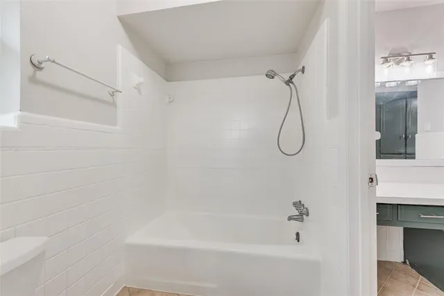 a bathroom with a bath tub with a shower