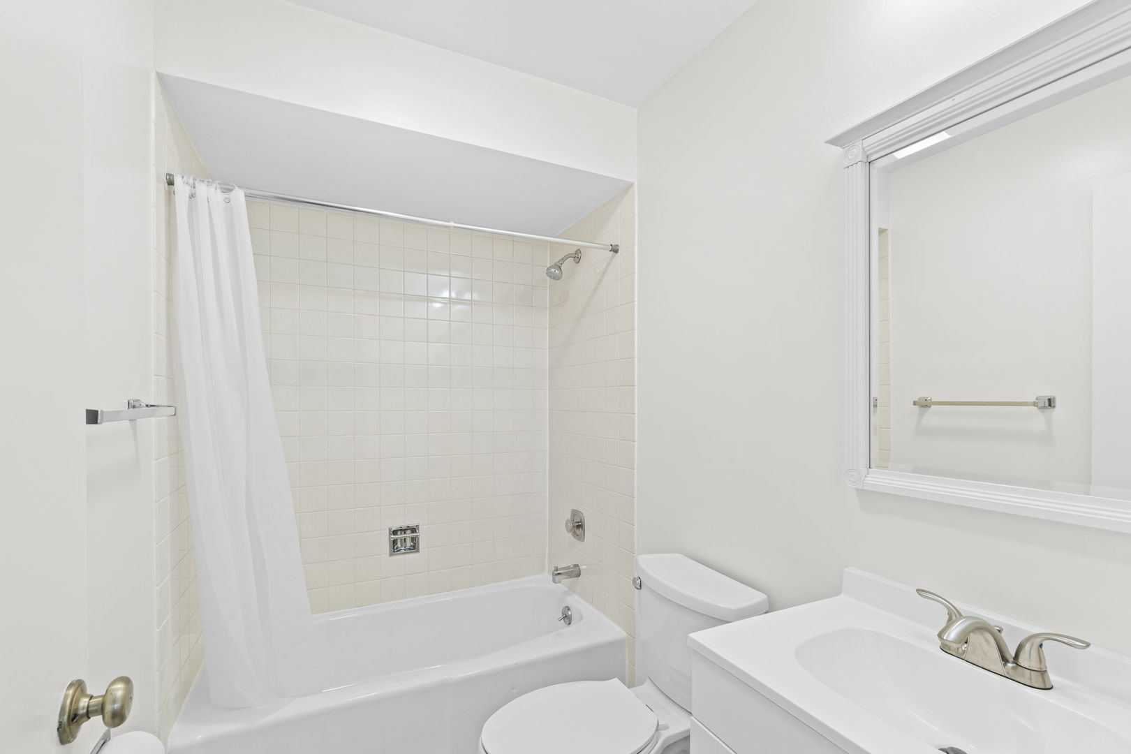 5880 Rembrandt Court, Unit C Hanover Park, IL 60133 - Photo 14 of 22 a bathroom with a bathtub shower sink vanity and toilet