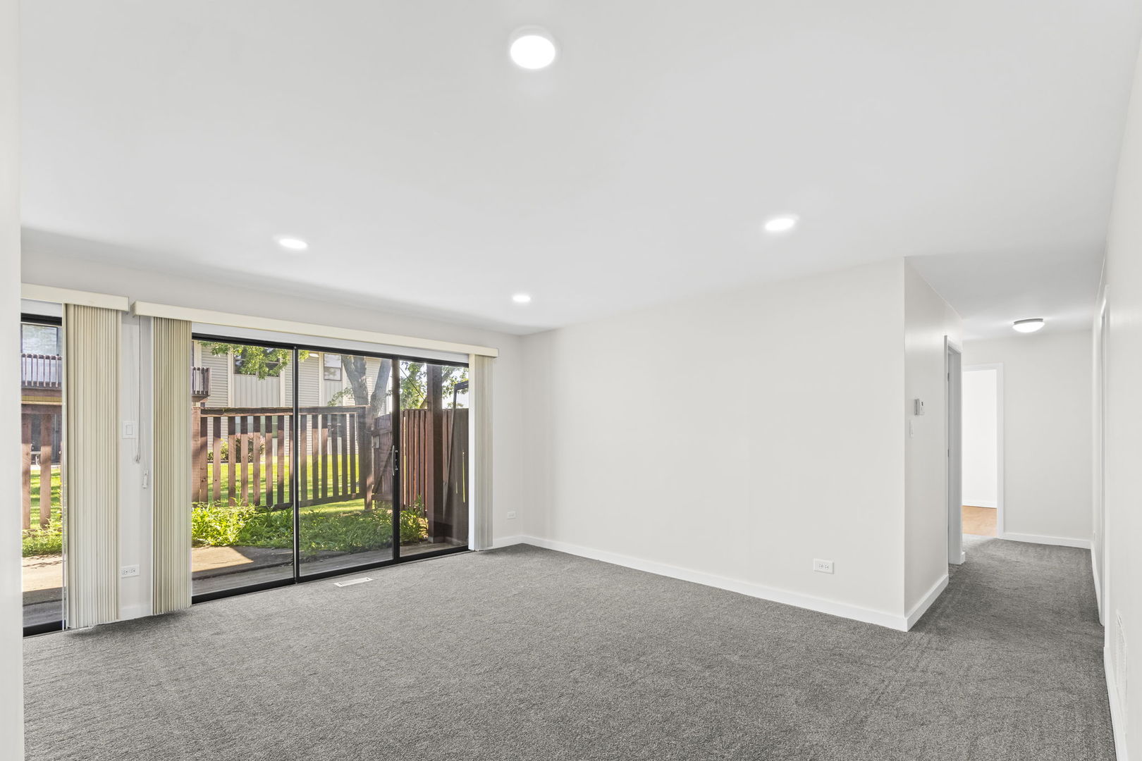 5880 Rembrandt Court, Unit C Hanover Park, IL 60133 - Photo 15 of 22 an empty room with floor to ceiling windows and yard