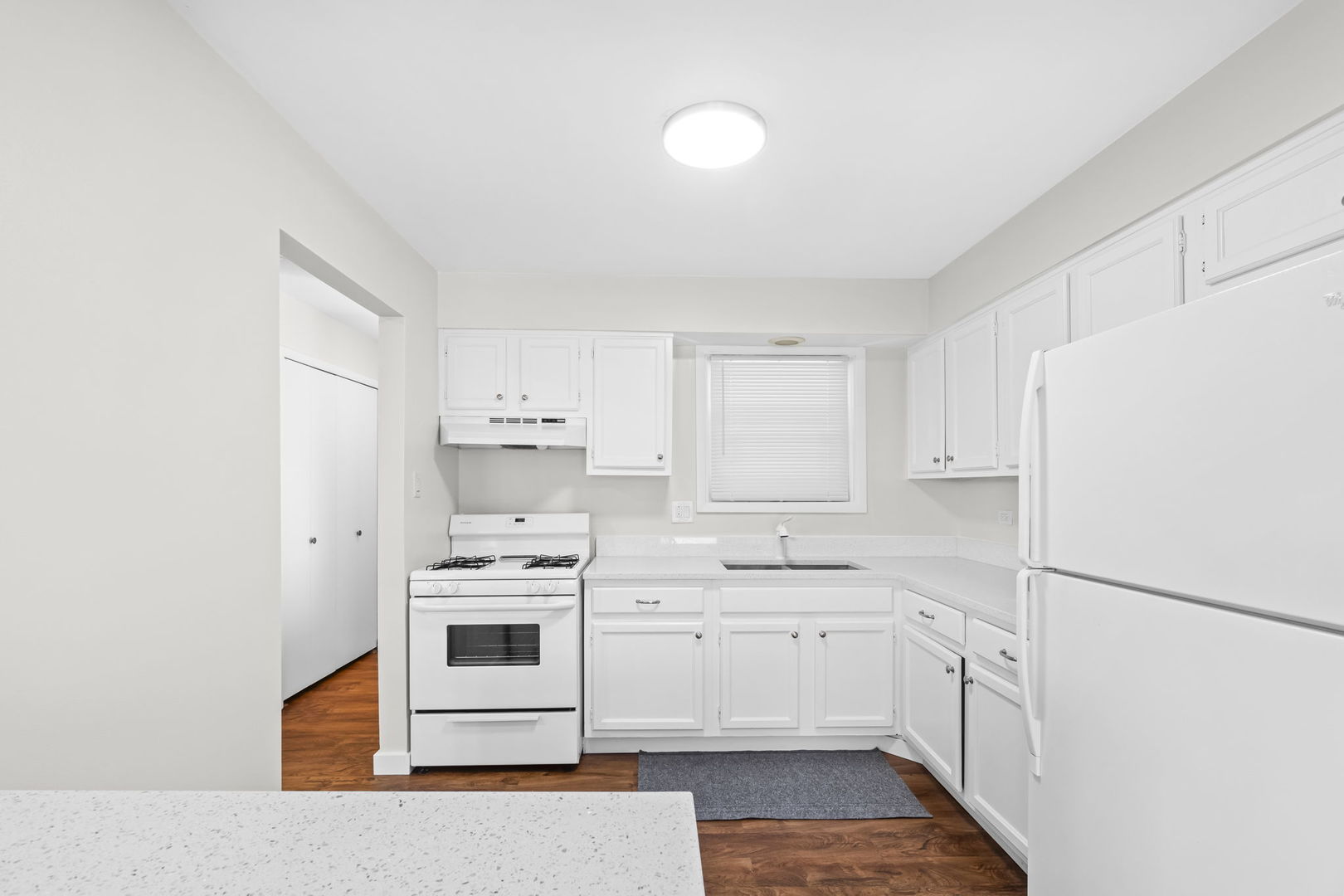 5880 Rembrandt Court, Unit C Hanover Park, IL 60133 - Photo 17 of 22 a kitchen with white cabinets and white appliances
