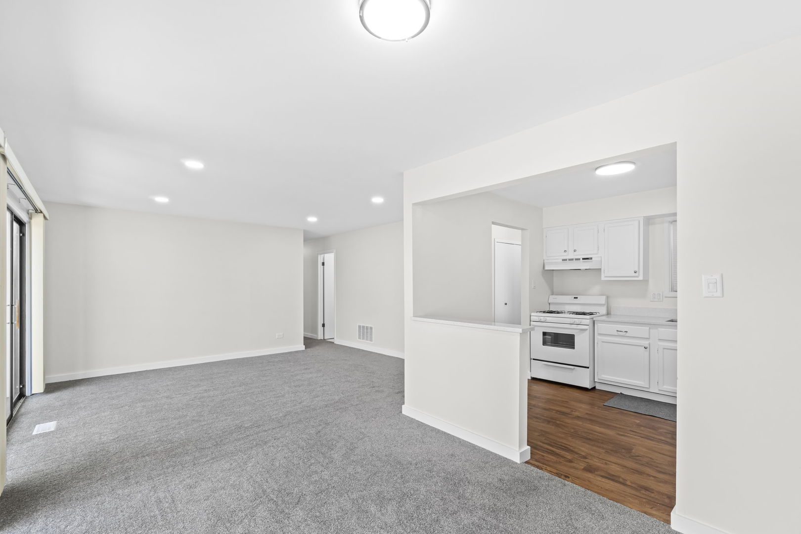5880 Rembrandt Court, Unit C Hanover Park, IL 60133 - Photo 18 of 22 a view of a kitchen with white cabinets and stainless steel appliances