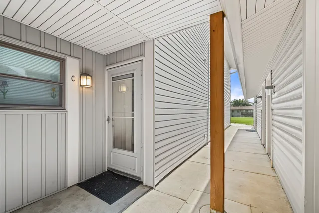 a view of a house with a door and wooden walls