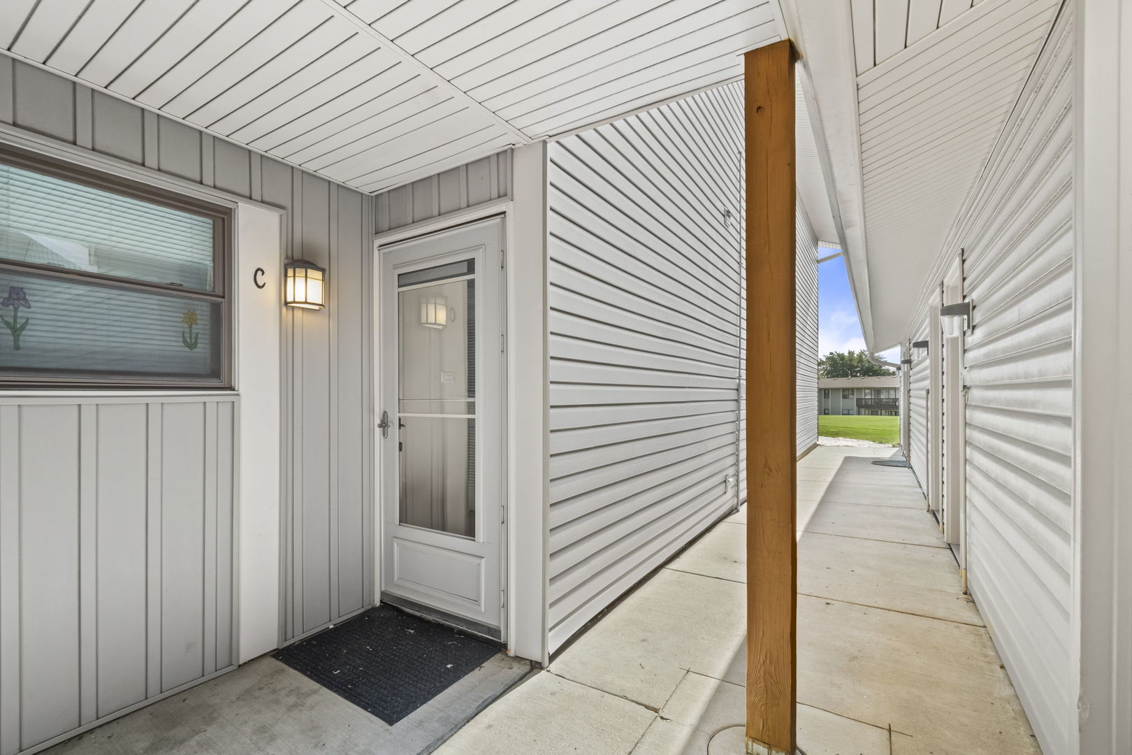 5880 Rembrandt Court, Unit C Hanover Park, IL 60133 - Photo 21 of 22 a view of a house with a door and wooden walls