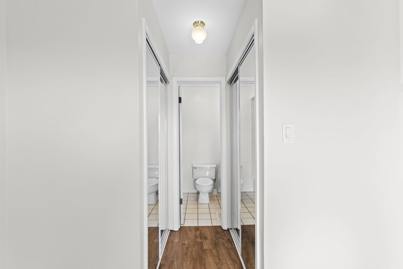 5880 Rembrandt Court, Unit C Hanover Park, IL 60133 - Photo 9 of 22 a view of a hallway with wooden floor and staircase