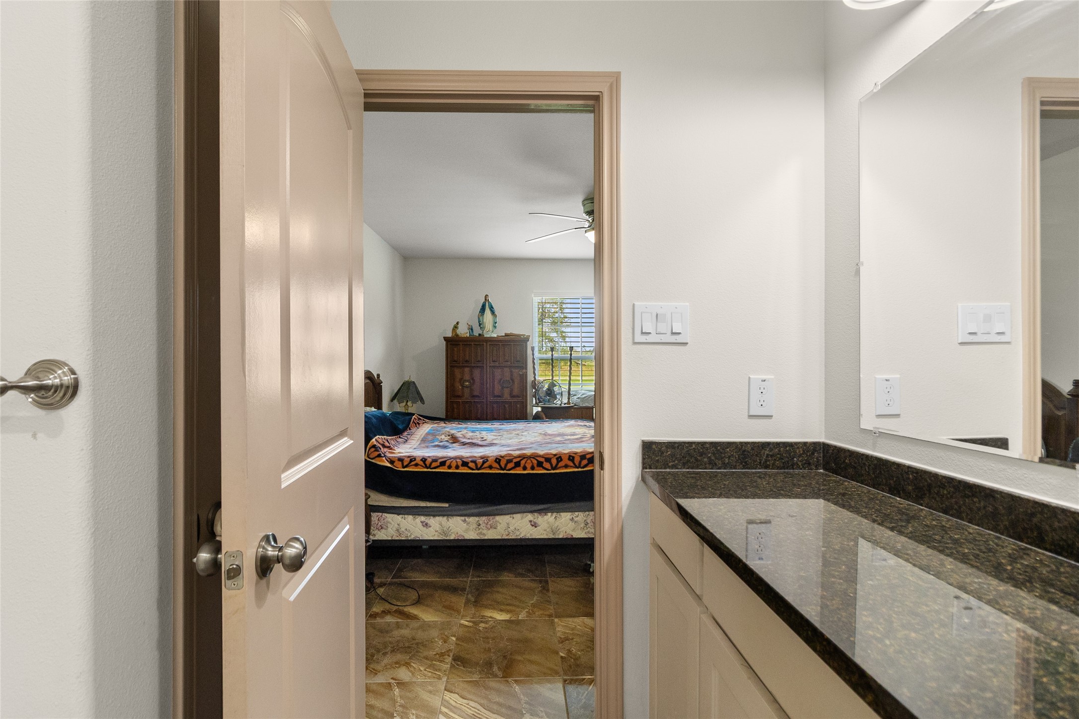 1545 County Road 2145 Cleveland, TX 77327 - Photo 14 of 22 a bathroom with a granite countertop sink and a mirror