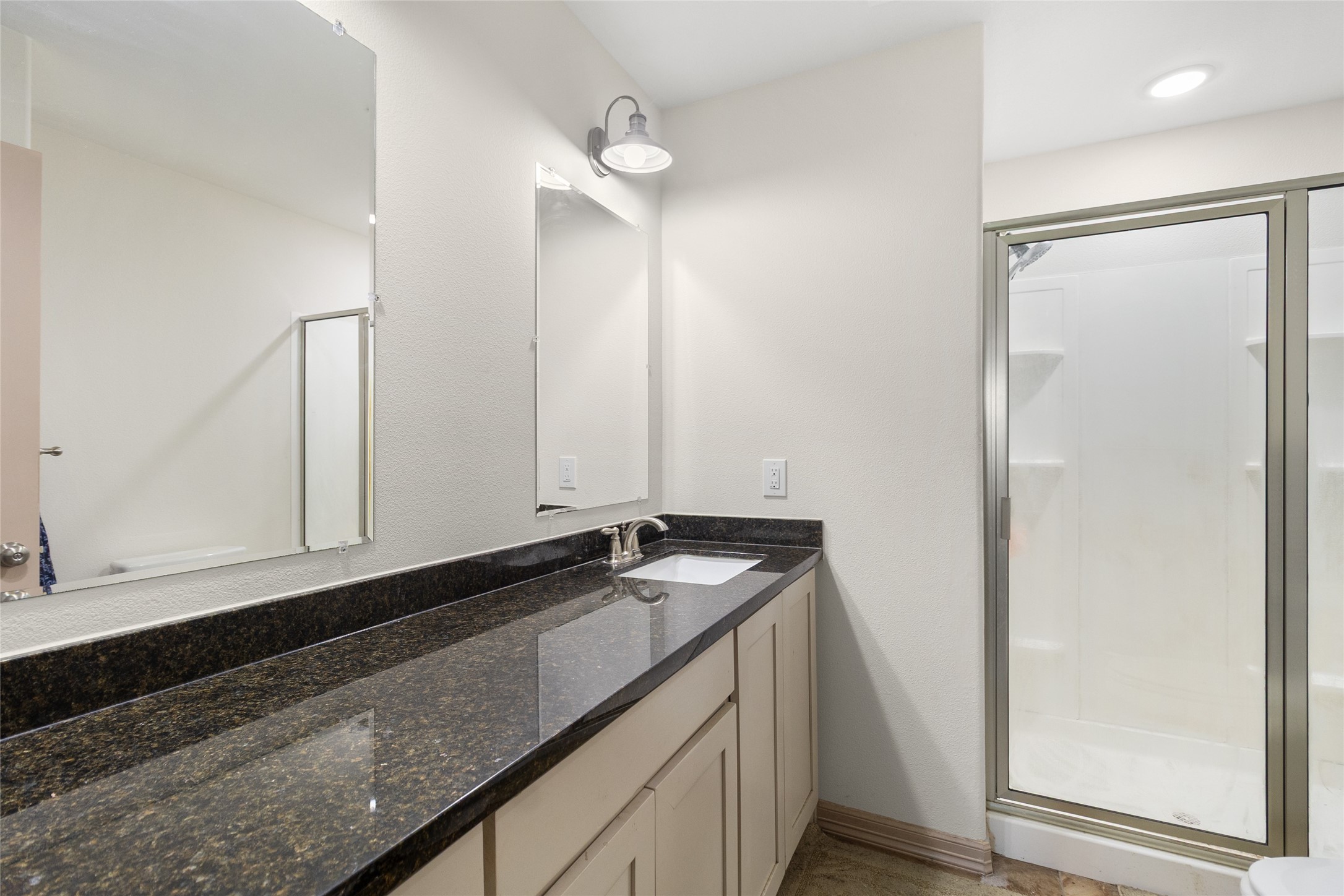 1545 County Road 2145 Cleveland, TX 77327 - Photo 15 of 22 a bathroom with a sink and a mirror