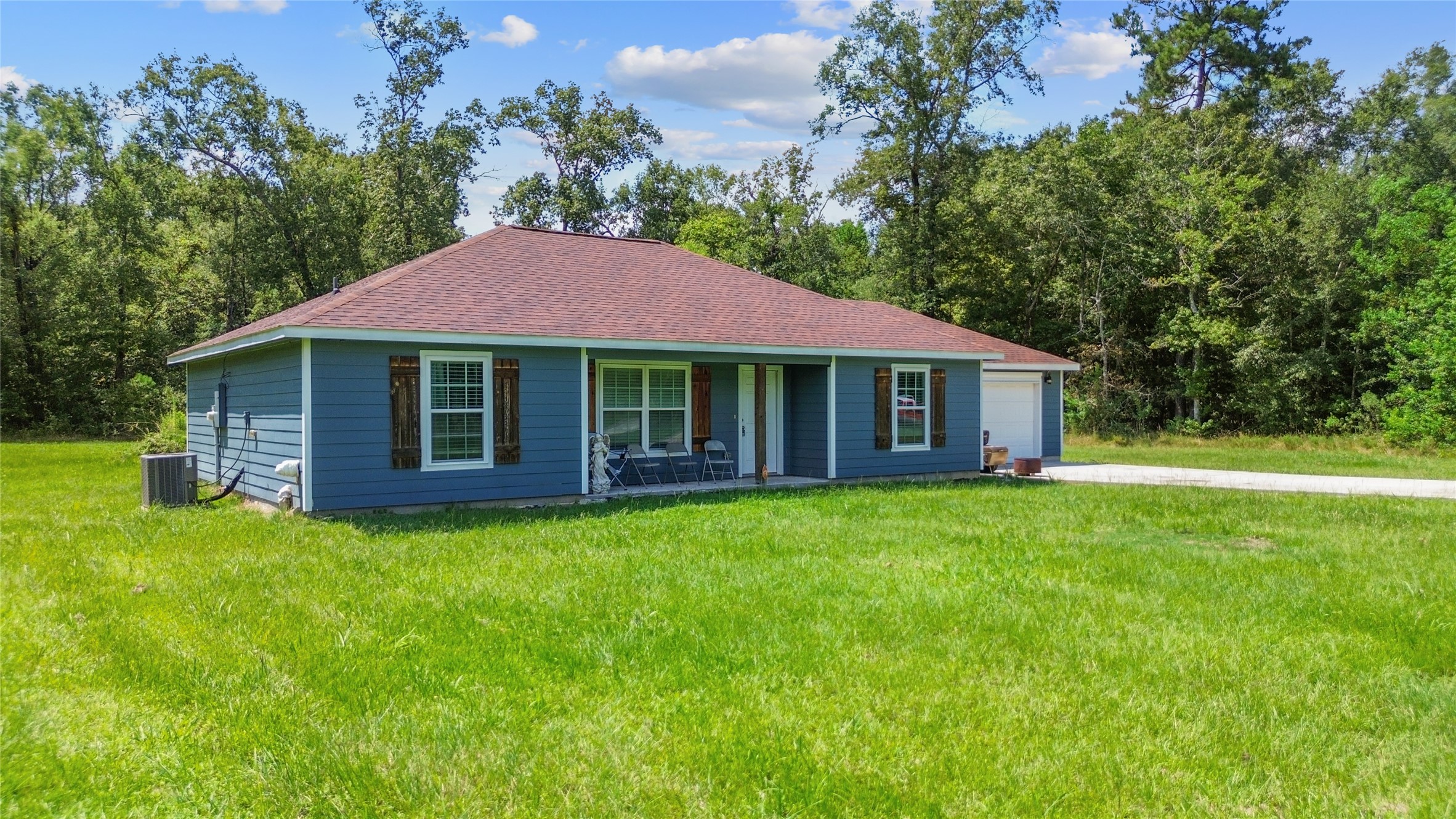 1545 County Road 2145 Cleveland, TX 77327 - Photo 3 of 22 a front view of a house with a garden