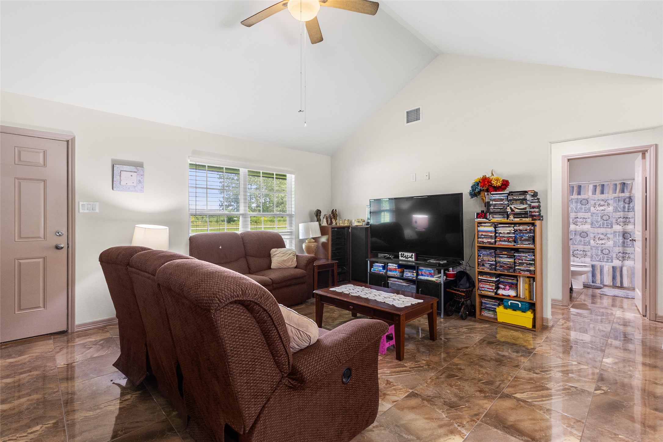 1545 County Road 2145 Cleveland, TX 77327 - Photo 6 of 22 a living room with furniture and a flat screen tv
