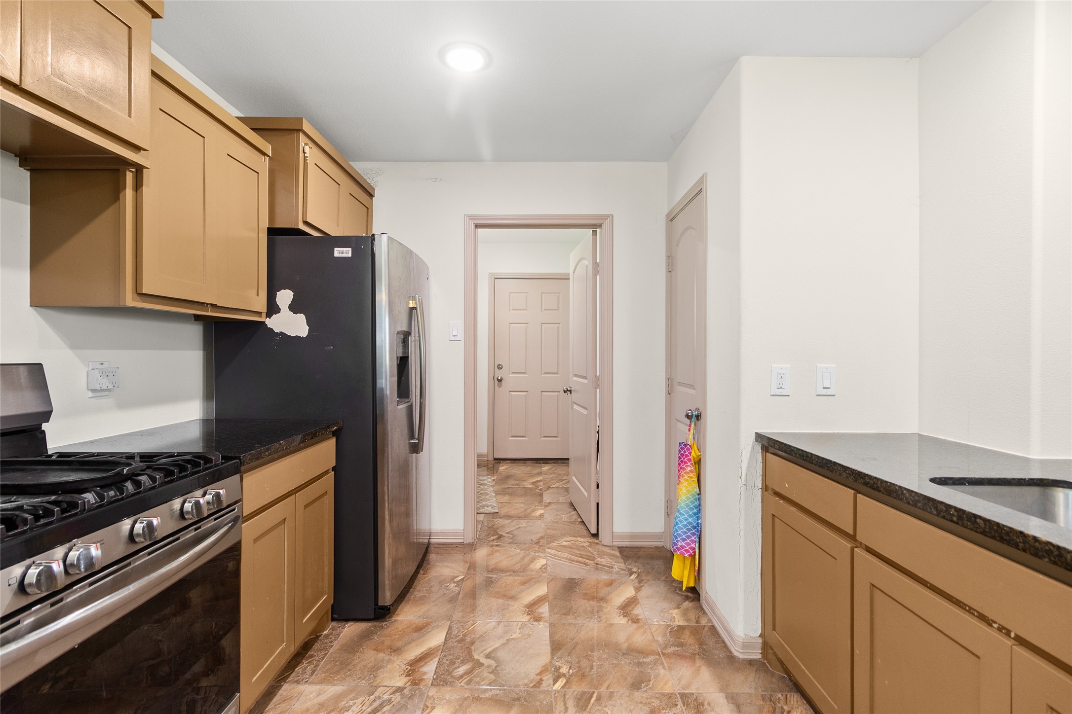 1545 County Road 2145 Cleveland, TX 77327 - Photo 10 of 22 a kitchen with stainless steel appliances a stove and a refrigerator