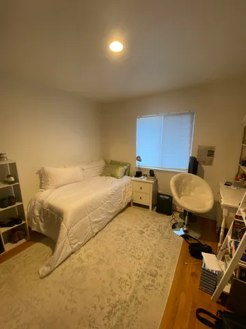 a bedroom with a bed a desk and chair