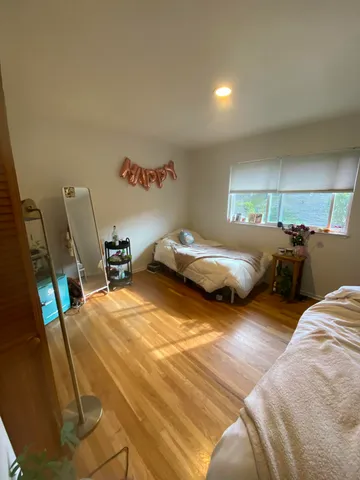 a bedroom with two beds and a couch