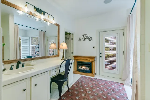 a bathroom with a tub sink a mirror and shower