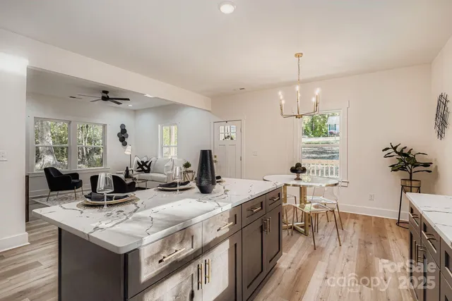 a kitchen with stainless steel appliances granite countertop a sink stove and wooden floor