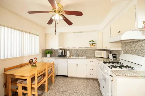 a kitchen with stainless steel appliances granite countertop a stove and a sink