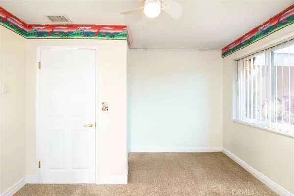a view of a hallway with furniture and a window