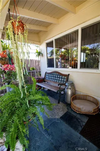 a view of a patio with table and chairs and potted plants