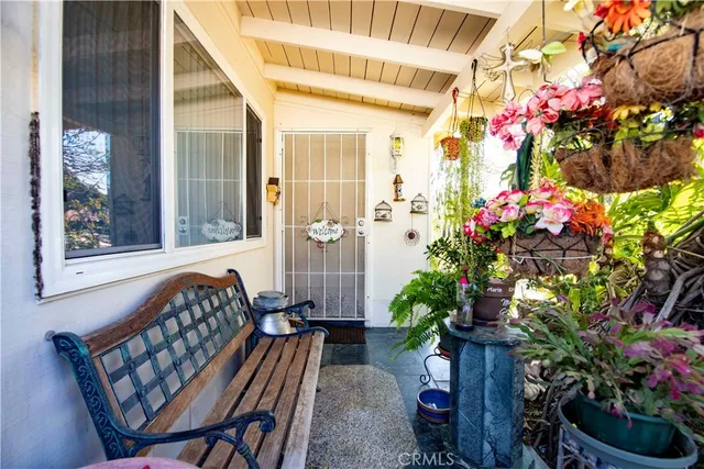 a view of a porch with a chairs and flower plants
