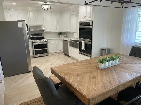 a kitchen with kitchen island a refrigerator stove and microwave