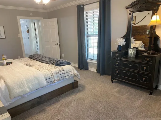 a bedroom with a bed and a mirror