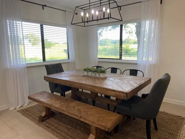 a dining room with furniture a rug and wooden floor