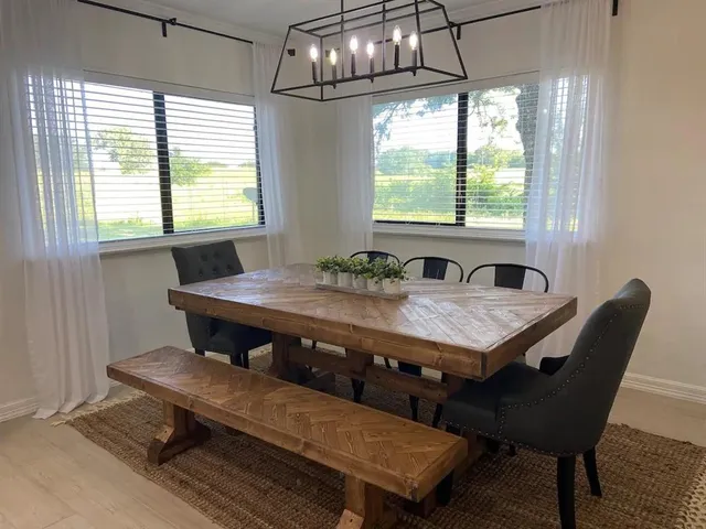 a dining room with furniture a rug and wooden floor