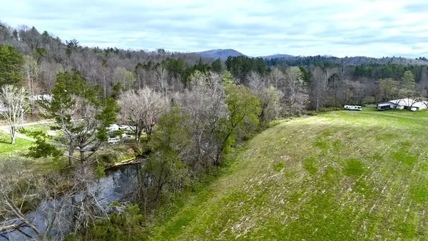 a view of a lake and green valley