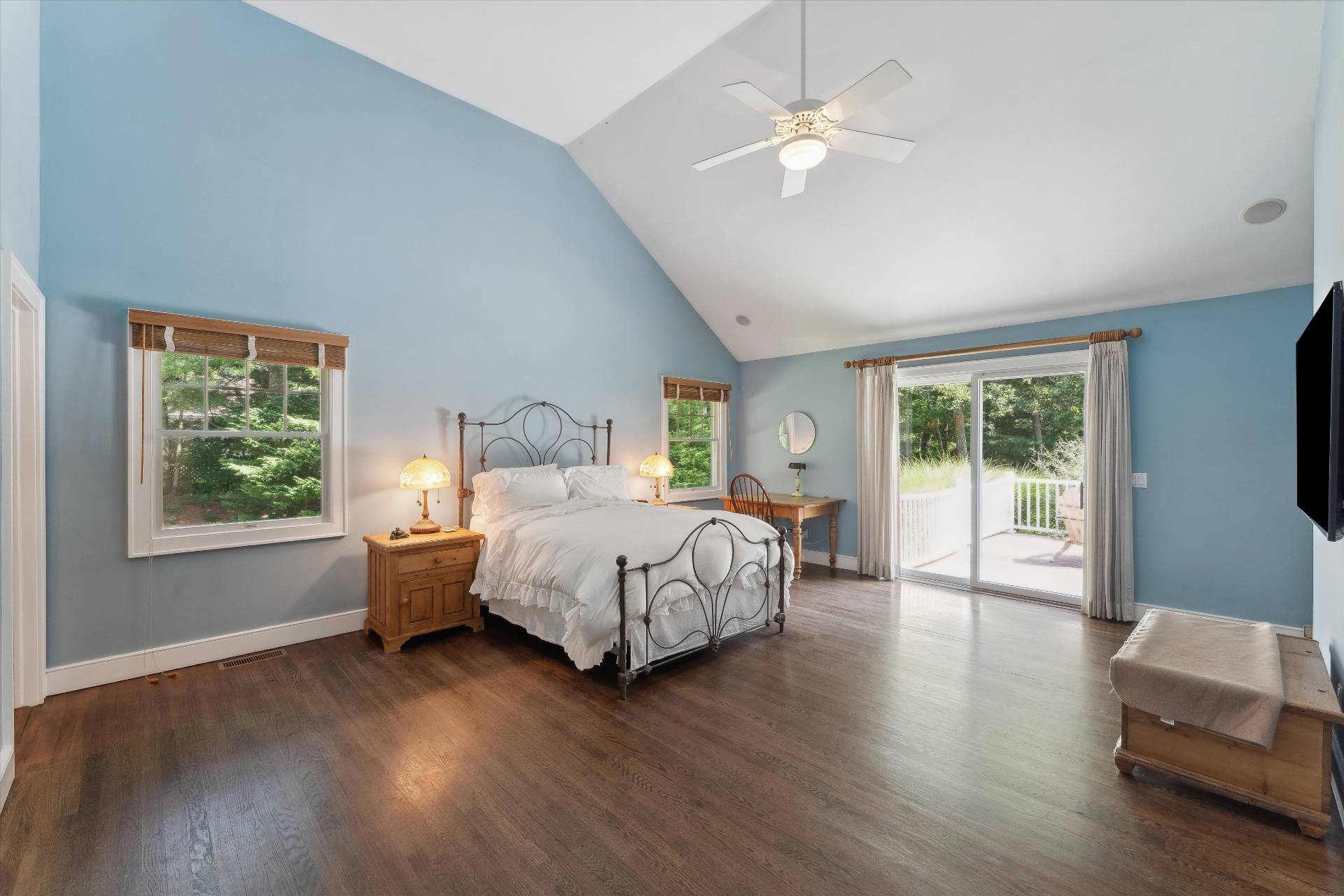 18 Old Fields Lane Quogue, NY 11959 - Photo 15 of 34 a spacious bedroom with a large bed a chandelier and windows