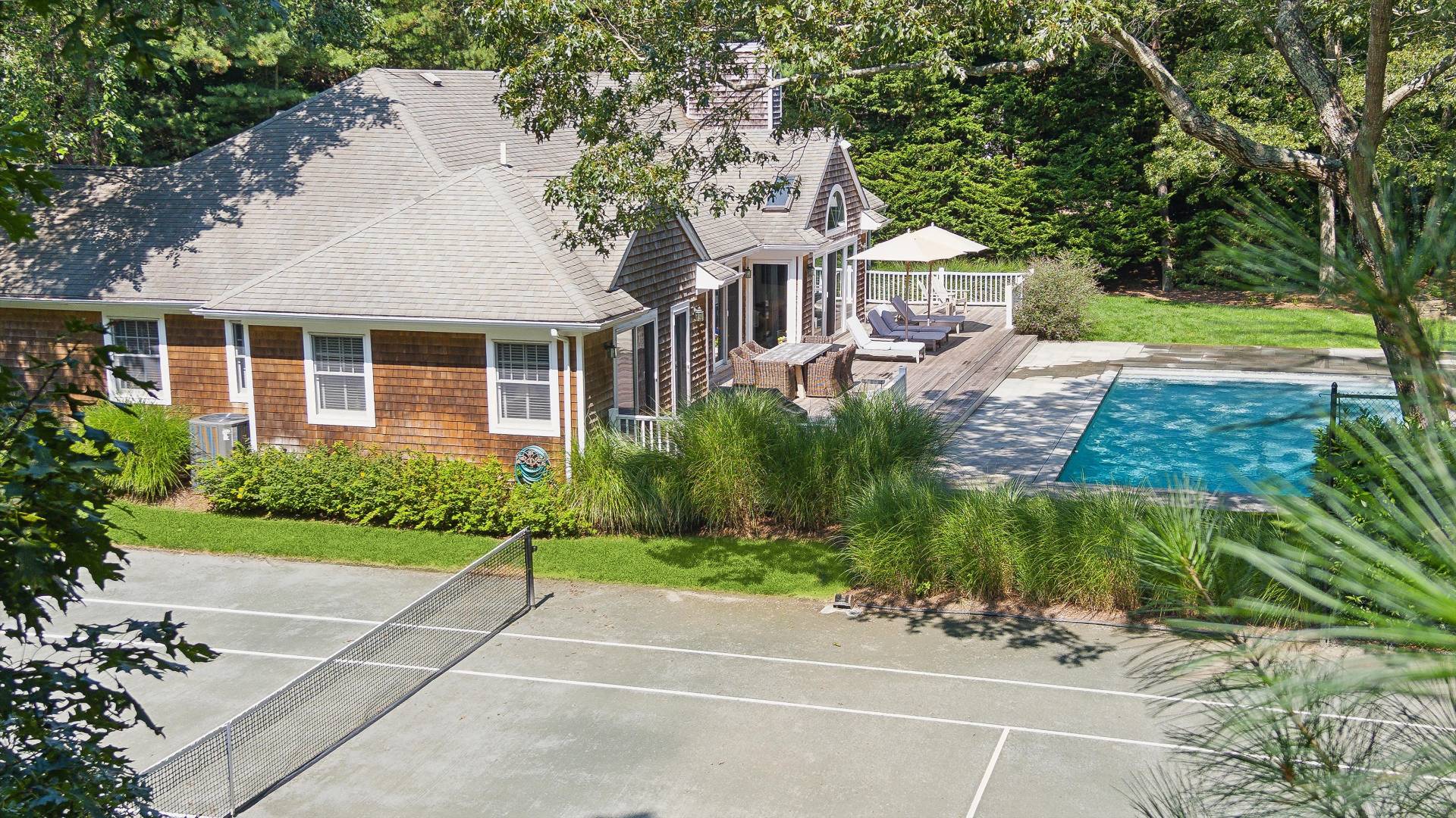 18 Old Fields Lane Quogue, NY 11959 - Photo 28 of 34 a front view of a house with a garden