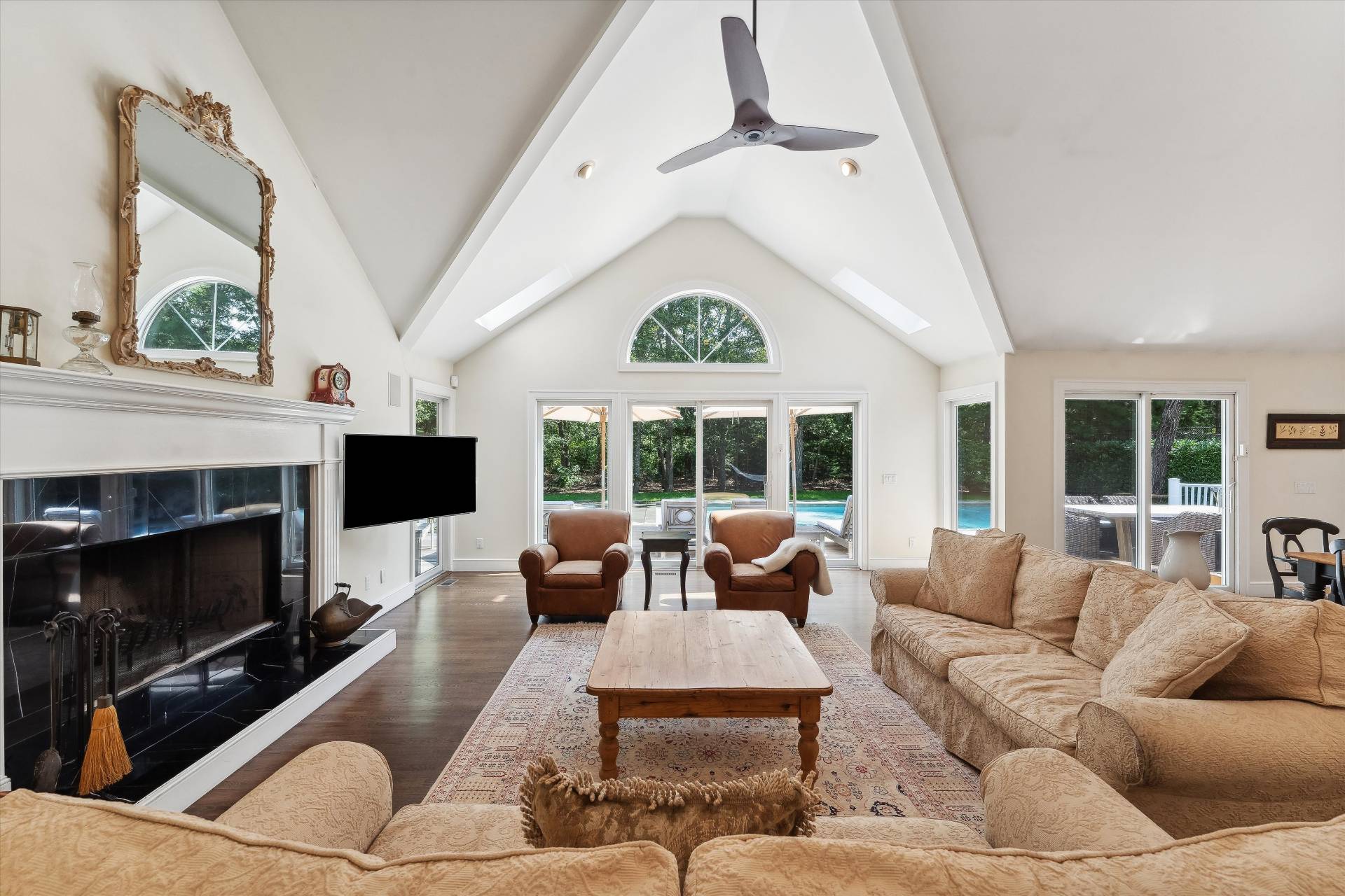 18 Old Fields Lane Quogue, NY 11959 - Photo 5 of 34 a living room with furniture a large window and a fireplace