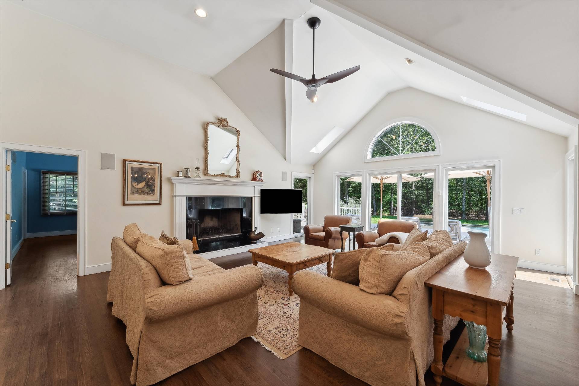 18 Old Fields Lane Quogue, NY 11959 - Photo 6 of 34 a living room with furniture a fireplace and a large window