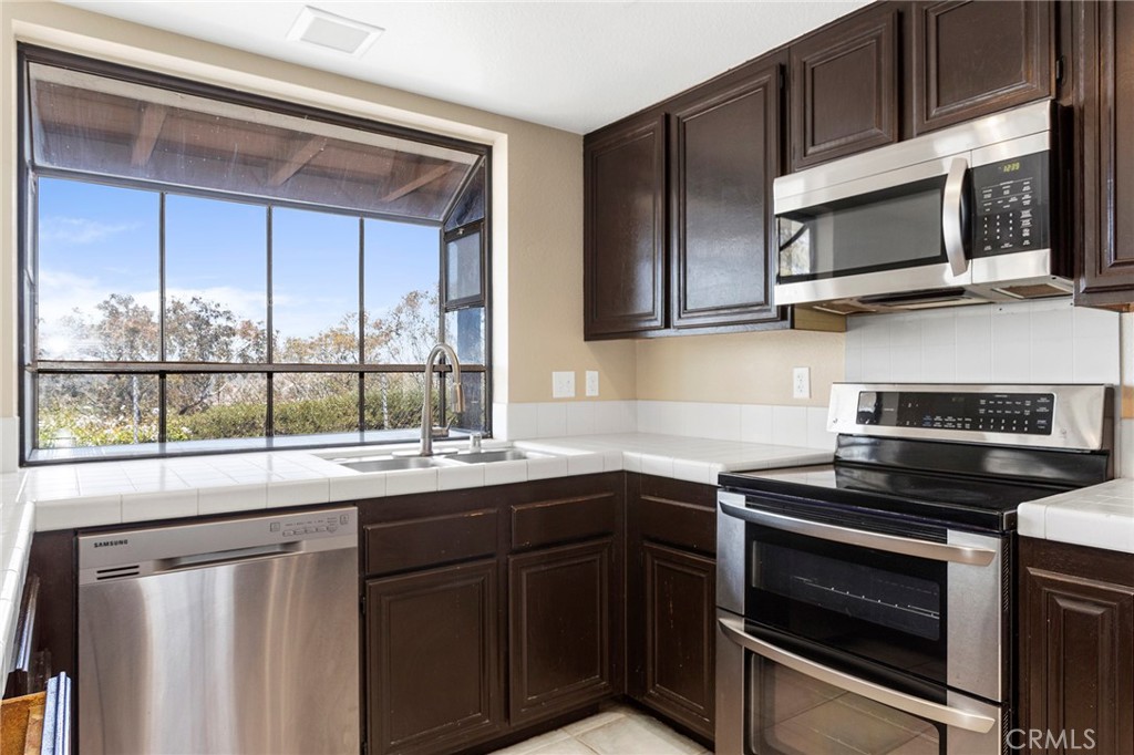 2881 Todd Street Oceanside, CA 92054 - Photo 11 of 41 a kitchen with a sink stove and microwave